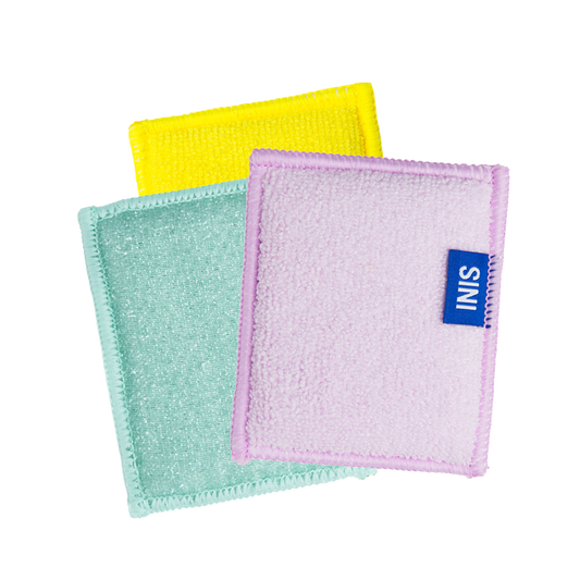 Three colorful washcloths with a visible brand label on a white background